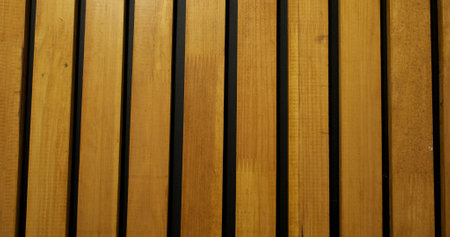 Lacquered wooden slats. Black wall with decor. Surface, abstraction, room interior.