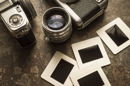Old camera and film placed on the floorの写真素材