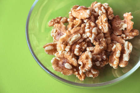 Glass bowl filled with walnutsの写真素材