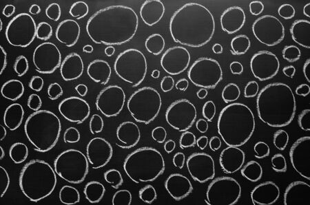 The whole surface of the blackboard was filled with circles drawn with chalkの写真素材