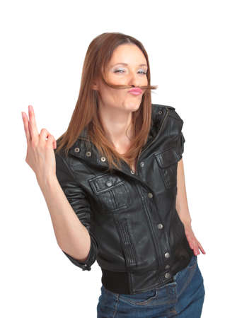 Pretty young woman fooling around with fake moustache. Isolated.の写真素材