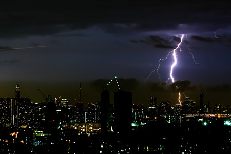 Thunder storm lighting bolt on the horizontal sky and city scapeの写真素材