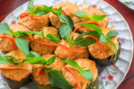 Top view Thai steamed curry fish in banana leaf cups decorated with basil leaf, (Hor Mok Pla)の写真素材