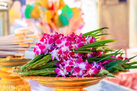 bunch of orchid flower in the tray for offeringの写真素材