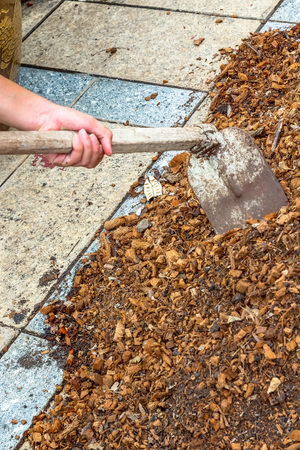 man worker using hoe equipment on the soil clay dirtの写真素材
