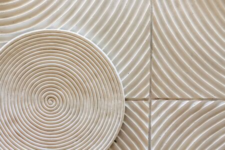 an abstract circle shape spin decorated on the wall as a background textureの写真素材