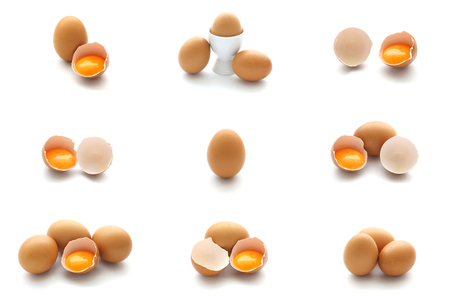 Isolated set of hen eggs and broken eggs on white backgroundの写真素材