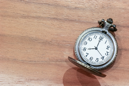 Luxury pocket watch on the wooden table with copy spaceの写真素材