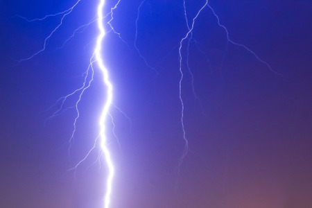 Dramatic thunder storm lighting bolt over the sky, god powerの写真素材