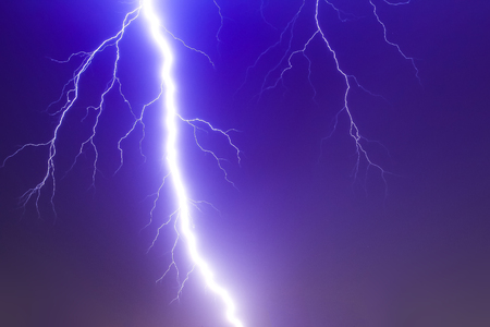 Dramatic thunder storm lighting bolt over the sky, god powerの写真素材