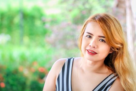 Portrait of Thai beautiful lady with red lip and blonde hairの写真素材