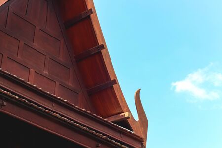 Wooden roof of Thai style house with blue skyの写真素材