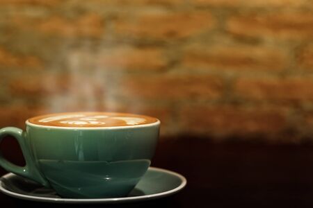 cup of the latte art coffee with warm lightの写真素材