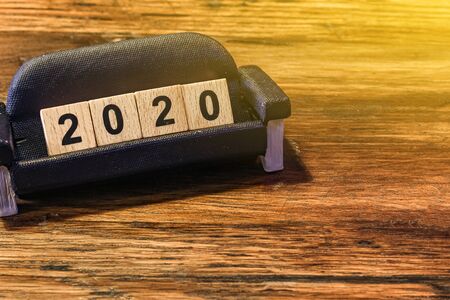 2020 dice on the miniature sofa on white backgroundの写真素材
