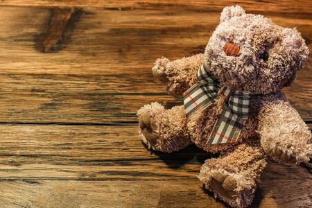 Brown teddy bear on the wood tableの写真素材