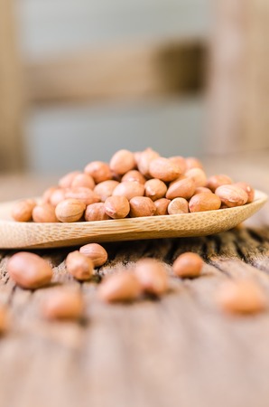 Raw peanut on wooden backgroundの写真素材