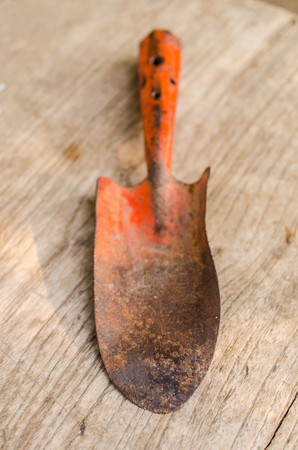 old garden trowel on wooden boardの写真素材