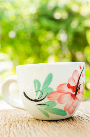 coffee cup on wooden board with blur backgroundの写真素材