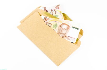 Stack of thai banknote in brown develope  isolated on white backgroundの写真素材