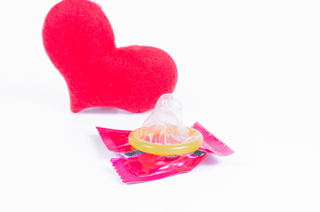 sex or love,condom with red heart valentine conceptの写真素材