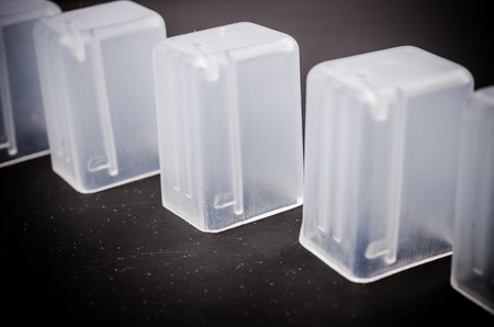 row of white plasstic cap on black backgroundの写真素材