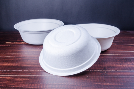 Eco unbleached plant fiber bowl on wooden tableの写真素材