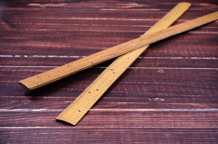 Retro wooden ruler on wooden boardの写真素材