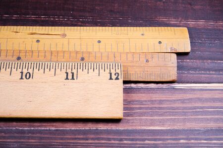 Retro wooden ruler on wooden boardの写真素材