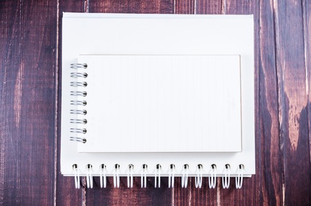 Notebook on wooden board の写真素材