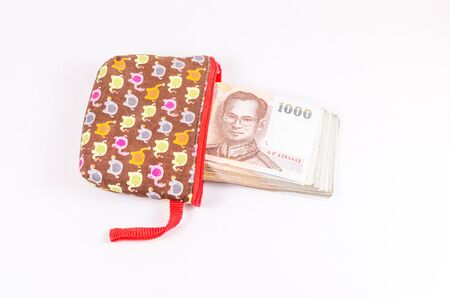 Stack of thai banknote from bag isolated on white backgroundの写真素材