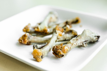 Chicken bone on white dishの写真素材