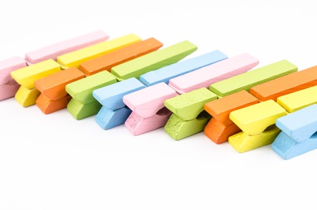 Group of colorful wooden clothespins isolated on white backgroundの写真素材