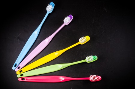 Set of colorful toothbrushs on blackboardの写真素材
