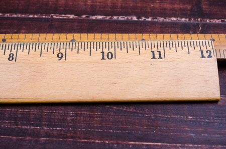 retro wooden ruler on wooden boardの写真素材
