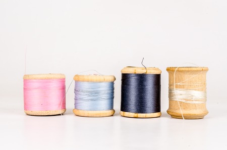 Vintage wooden thread spool with isolated on white backgroundの写真素材