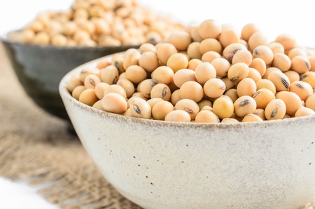 soybeans in ceramic bowl on sackcloth background