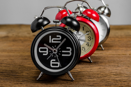 Retro alarm clock on wooden tableの写真素材