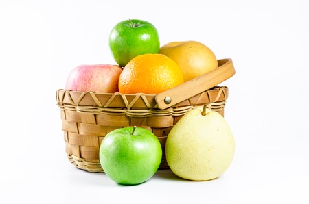 ripe fruit in wicker basket isolated on white backgroundの写真素材