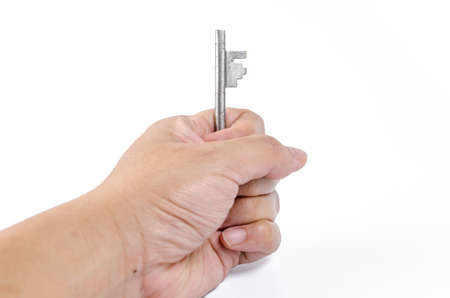 key in hand on white backgroundの写真素材
