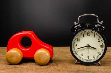 wooden toy car with retro alarm clock,Concept of time to travelの写真素材