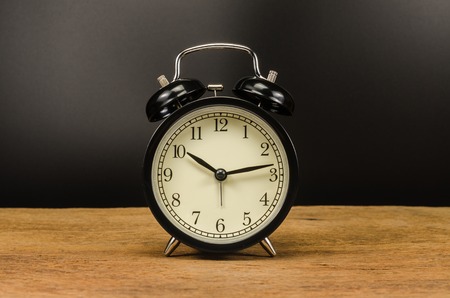 Retro alarm clock on wooden tableの写真素材