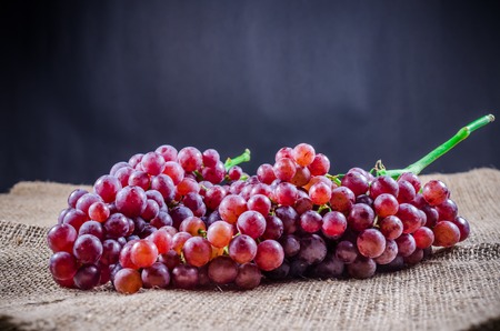 red grape on sackclothの写真素材