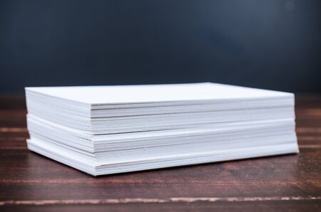 Close up stack of white paper on wooden boardの写真素材