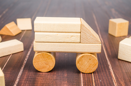 Car from wooden toy blocks on wooden board background, concept imageの写真素材