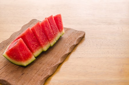 Fresh sliced watermelon on wooden board backgroundの写真素材