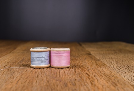 vintage wooden spool thread on wooden boardの写真素材