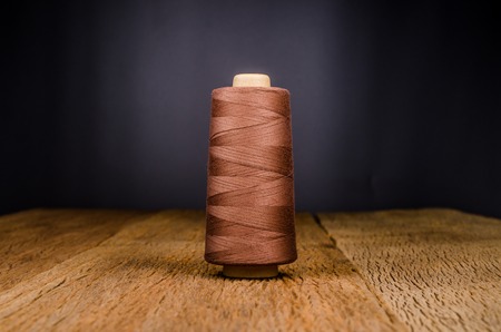 vintage spool thread on wooden boardの写真素材