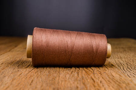 vintage spool thread on wooden board