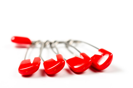 Heap of safety pins isolated on white backgroundの写真素材