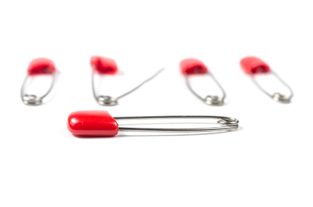 Heap of safety pins isolated on white backgroundの写真素材